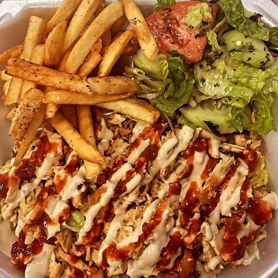 Habibi Mediterranean Grill's chicken shawarma plate with fries, salad, and white and red sauces.